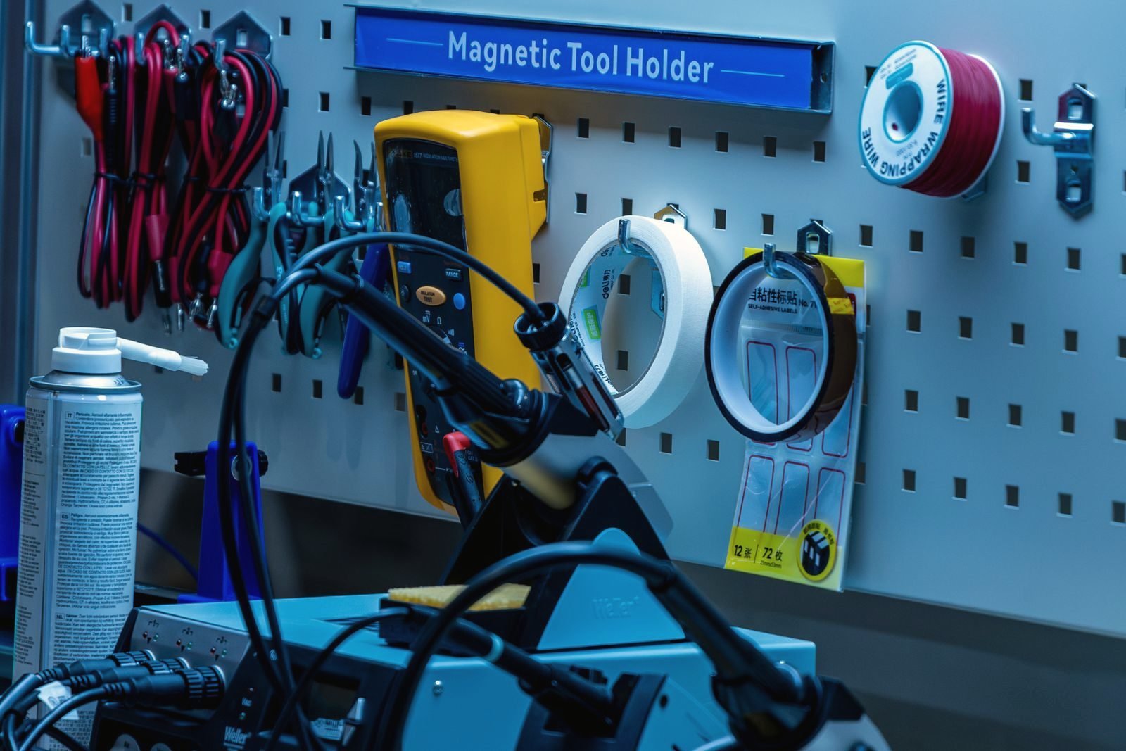 A workshop pegboard hung with tools and leads